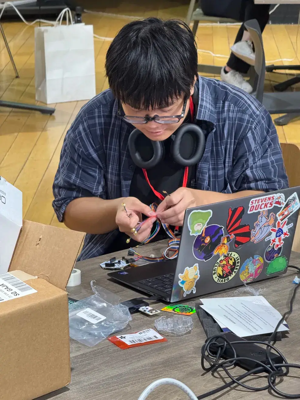 Engineer working with cables and a computer on the prototype hardware